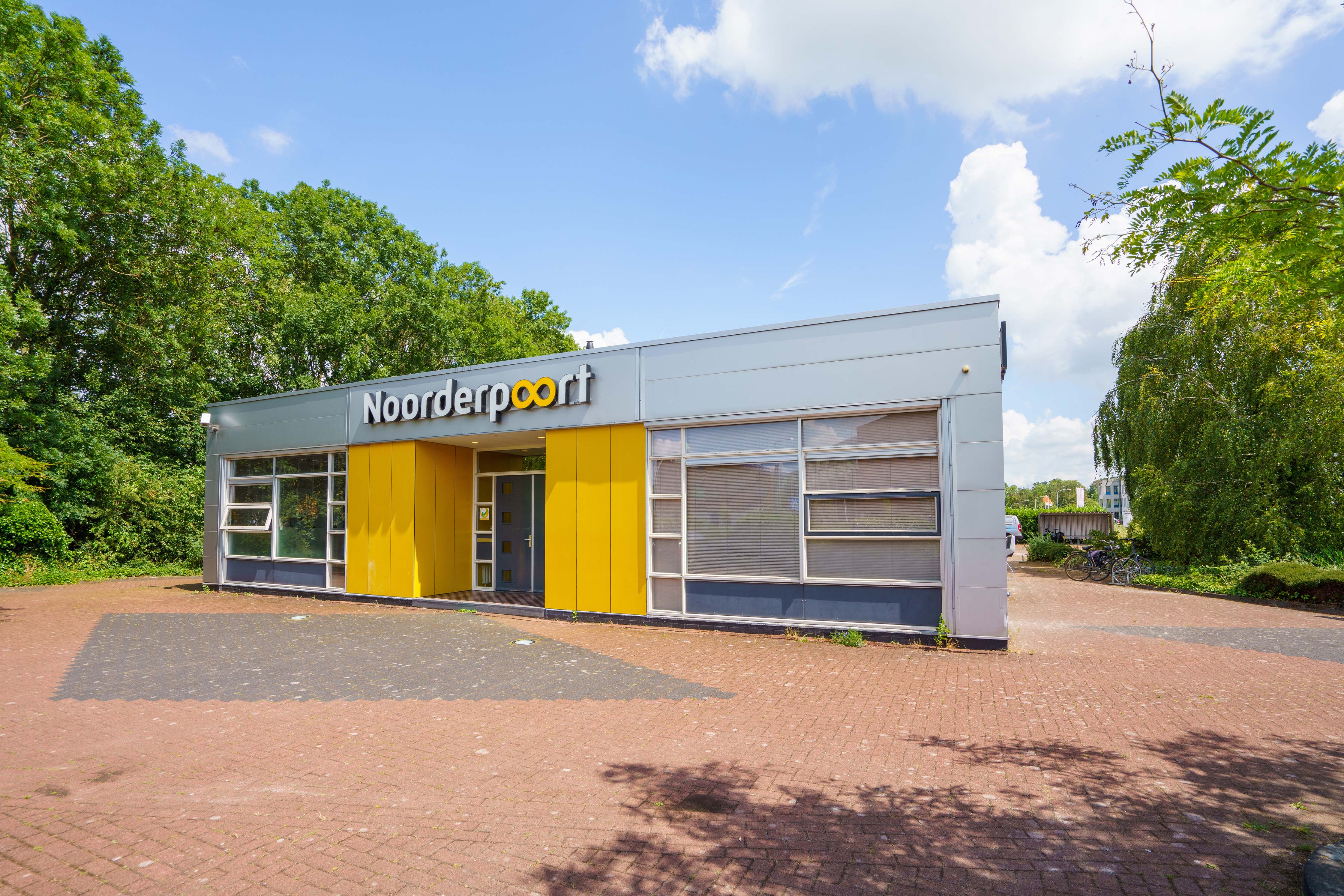 Entree van het Noorderpoort-onderwijsgebouw aan Zernikepark 21 in Groningen, omgeven door groen