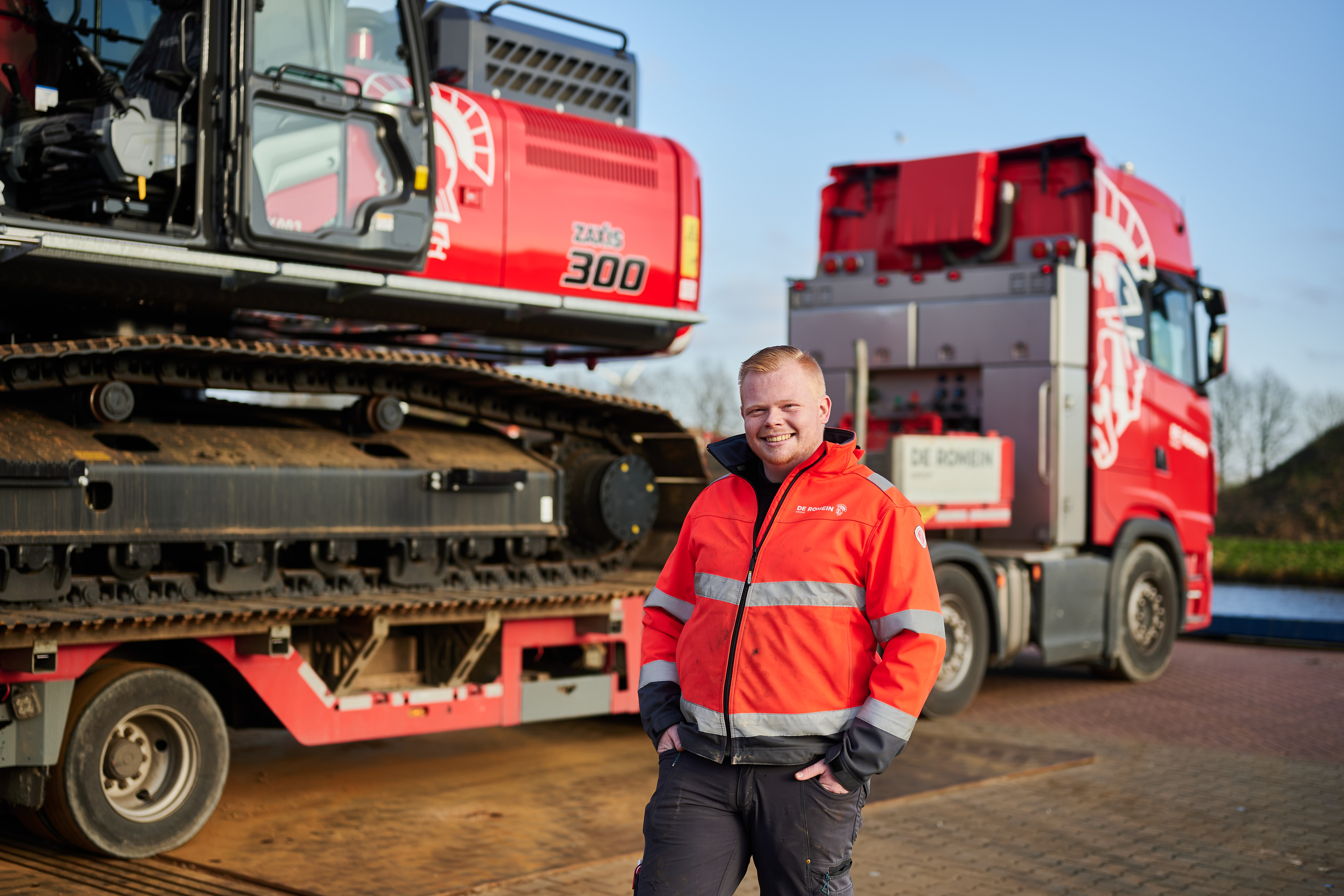 Leerling volgt praktijkles logistiek bij Noorderpoort met kraanmachine en vrachtwagen op de achtergrond.
