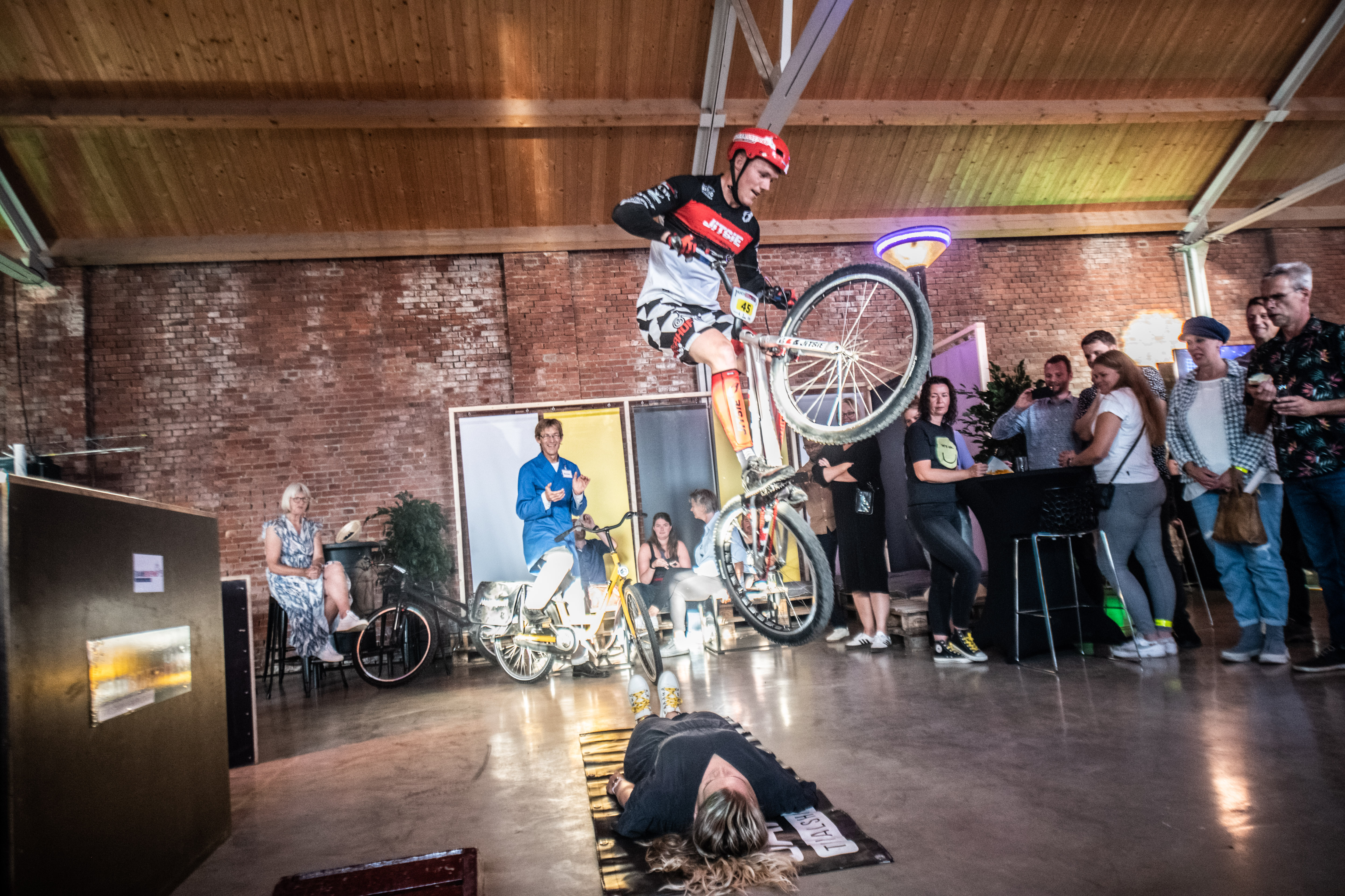 Fietstrialrijder voert stunt uit over liggende persoon tijdens jubileumevenement Noorderpoort